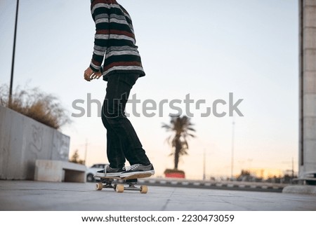 Similar – teenager practicing with skateboard at sunrise city