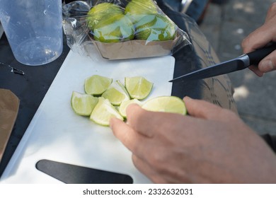 Caucasian hands cutting lime for mojito with a knife - Powered by Shutterstock