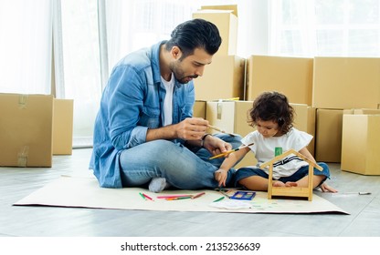 Caucasian Handsome Father, Little Happy Adorable Kid Daughter Sitting On Floor, Playing Together, Painting, Using Color Pencil For Drawing, Doing Homework, Moving House Or Apartment With Paper Boxes