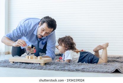 Caucasian Handsome Father Playing Toys With His Little Cute Daughter At Home After Work. Family And Education Concept.