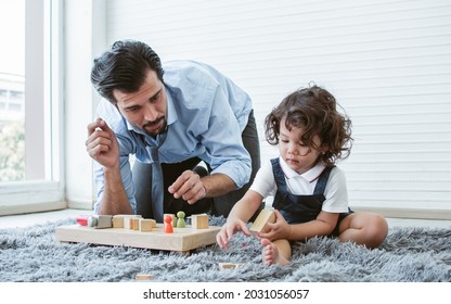 Caucasian Handsome Father Playing Toys With His Little Cute Daughter At Home After Work. Family And Education Concept