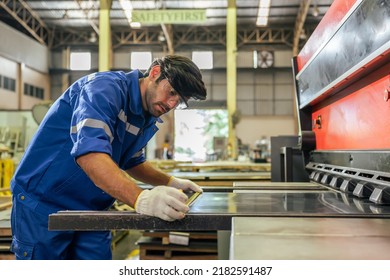 Caucasian handsome male industrial worker work in manufacturing plant. Attractive young man industry factory engineer people processes orders and product alone at manufacturing plant with happiness. - Shutterstock ID 2182591487