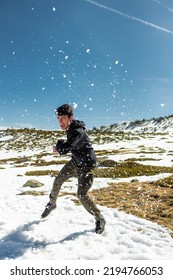 Caucasian Handsome Man Fighting In The Middle Of A Snowy Place. He Is Wearing A Black Sweeter