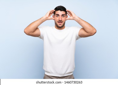 Caucasian handsome man over isolated blue background with surprise expression - Shutterstock ID 1460730263