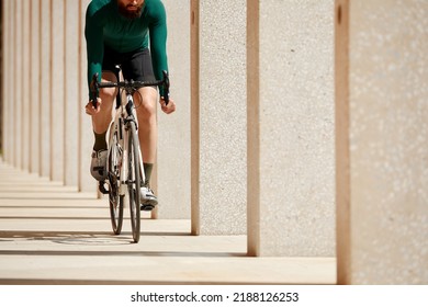 Caucasian Handsome Young Man In Protective Helmet Goes Out For Bicycle Ride Through City Streets On Blurred Background. Cyclist Male Ride Bike Outdoors In Urban.