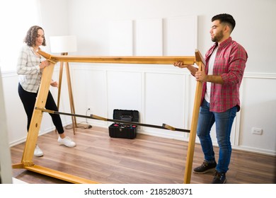 Caucasian Handy Couple Building A Self Assembly Bed Frame And Using Tools After Buying New Furniture 