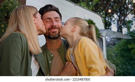 Caucasian Happy Loving Family Talking Outdoors Dad Touching Nose Of Little Daughter Child Girl And Mother Wife Kissing Bearded Father On Cheek Hugging Love Relationship Affectionate Cuddling Together