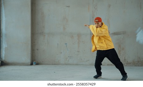 Caucasian hipster shows or practicing footstep at street, urban city. Motion shot of young stylish break dancer moving and stretch arm and leg. Outdoor sport 2024. Gray background. Hiphop. - Powered by Shutterstock