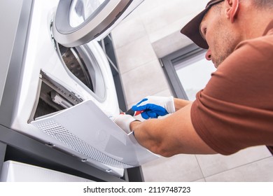 Caucasian Home Appliances Technician In His 40s Repair Broken Washer Inside A Home Bathroom. 