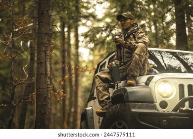 Caucasian Hunter During Hunting Season Taking Short Coffee Break - Powered by Shutterstock