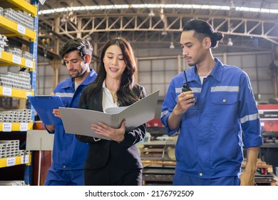 Caucasian industrial male worker and businesswoman working in factory. Attractive manufactory industry engineer people walking and processes products at manufacturing plant warehouse with happiness.