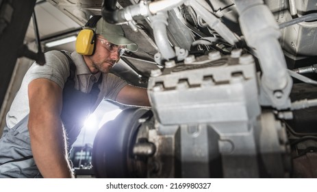 Caucasian Industry Mechanic in His 40s Performing Diesel Pusher Maintenance. Servicing Motor Coach.