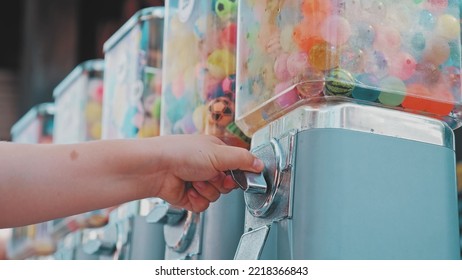 Caucasian Kid Buying Bouncy Rubber Ball In Toy Vending Machine At Amusment Park Or Festival