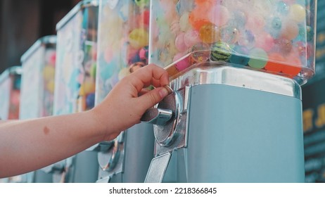 Caucasian Kid Buying Bouncy Rubber Ball In Toy Vending Machine At Amusment Park Or Festival