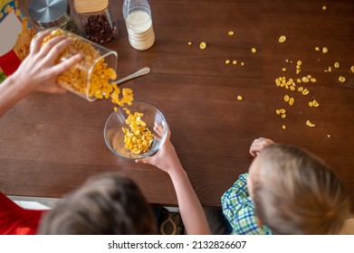 Caucasian Kid Making Breakfast Cereal For Two