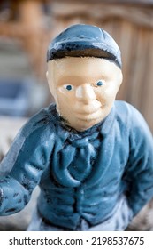 Caucasian Lawn Jockey Wearing Blue Cap.	