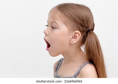 Caucasian Little Girl Of 6 Years With Wide Open Mouth To Show Difficulty In Speech, Sound Pronunciation And Voice Combined With Impaired Articulatory Motility And Speech Breathing