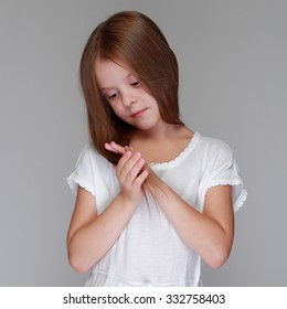 Caucasian lovely little girl with long hair on gray background - Shutterstock ID 332758403