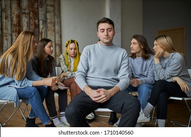 caucasian male alcohol addict is emotionally devastated, sit in the distance from anonymous alcoholics club, his first visit of therapy