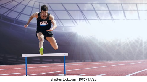 Caucasian male athlete jumping over a hurdle against sports field in background. sports competition and tournament concept - Powered by Shutterstock