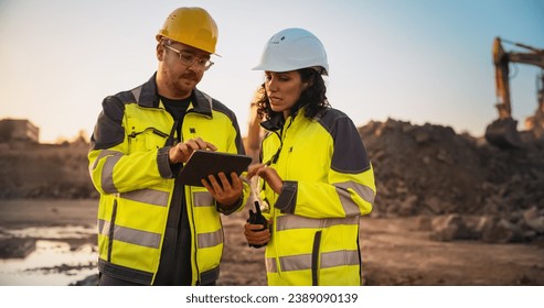 Caucasian Male Civil Engineer Talking To Hispanic Female Inspector And Using Tablet Computer On Construction Site of a New Building. Real Estate Developers Discussing Business, Excavators Working. - Powered by Shutterstock - Get 15% off with code: PIKWIZARD15