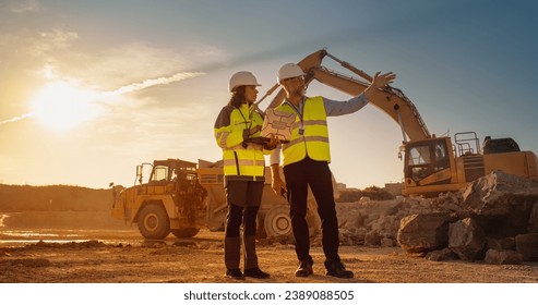 Caucasian Male Engineer Talking To Female Hispanic Architect With Laptop On Construction Site Of Apartment Building. Real Estate Developer Discussing Infrastructure. Heavy Machinery Working. Cinematic - Powered by Shutterstock