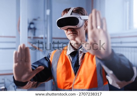 Caucasian male engineer using vr headset for virtual environment interaction in industrial setting.