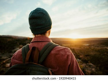 Caucasian Male Free Spirit Wearing Beanie Walking In Wilderness Watching Sunset