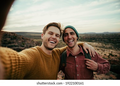 Caucasian Male Friends Hiking In Wilderness Taking Selfie With Cellular Device Embracing The Outdoors