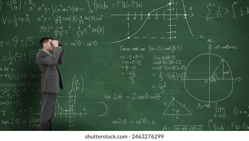 Caucasian male great-grandson wearing suit, looking through binoculars. He has short brown hair, standing in front of a chalkboard filled with complex math equations - Powered by Shutterstock