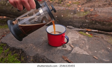 Caucasian Male Hiker Tourist Pouring Steaming Hot Coffee into Metal Cup from French Press Brewing Jug - Powered by Shutterstock