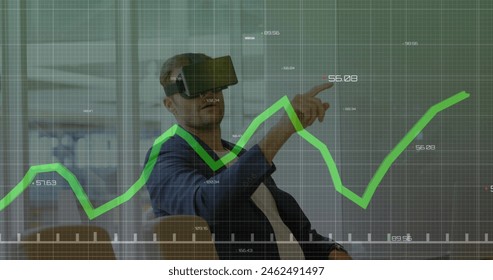 Caucasian male instructor wearing virtual reality headset pointing at graph. He has short gray hair, wearing dark shirt, analyzing data - Powered by Shutterstock - Get 15% off with code: PIKWIZARD15