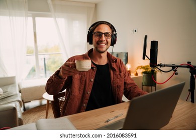 Caucasian Male Popular Free Lance Podcaster Drinking Coffee And Smiling While Enjoying Live Conversation