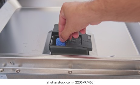 Caucasian Male Putting Detergent Capsule Pill into Dispenser on Dishwasher Door - Shutterstock ID 2206797463