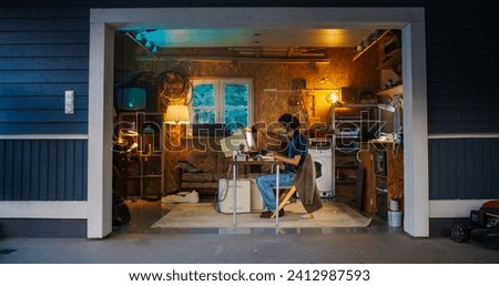 Caucasian Male Software Engineer Programming On Old Desktop Computer In Retro Garage In The Evening. Ambitious Man Starting an Innovative Fintech Startup Company In Nineties. Nostalgia Concept.