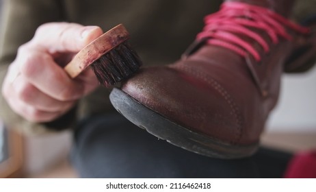 Caucasian Male Using Soft Horsehair Brush to Apply Brown Shoe Shine Wax to Protect and Impregnate Leather Boots Shoes Wide - Powered by Shutterstock