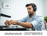 Caucasian man artist DJ mixing and scratching music mixer controller. Attractive male musician having fun mixing music on console touching buttons and playing electronic music in living room at home.