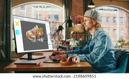 Caucasian Man Design Video Game at His Personal Computer in a Creative Office. Man Designing Clothing For Charachter on His Desktop Computer. Game with Graphics and Social Media Metaverse Gameplay.