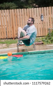 Caucasian Man Does Cannon Ball Jumps Into Blue Backyard Pool
