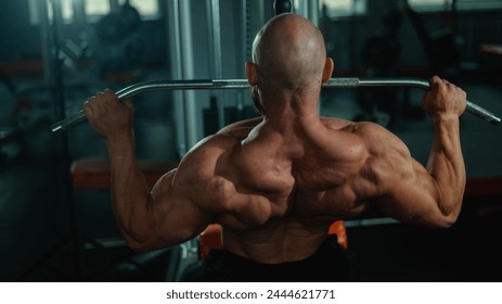 Caucasian man doing lat pull-downs on a machine. 