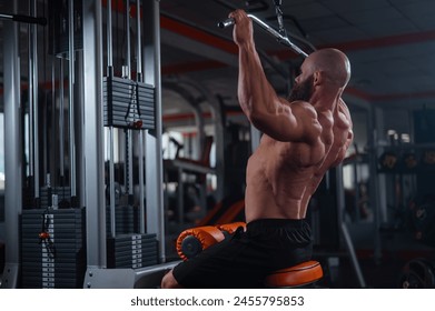 Caucasian man doing lat pull-downs on a machine.  - Powered by Shutterstock