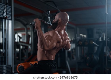 Caucasian man doing lat pull-downs on a machine. 