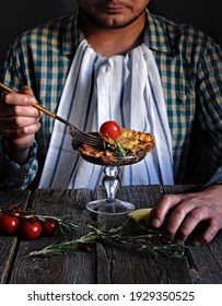 Caucasian Man Eating Lasagna On Black Background