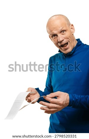 Caucasian man examining receipts while preparing expense report for reimbursement pencil in hand, amused pragmatic smile, blue shirt, piles of itemized slips, smallbusiness