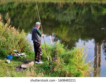Caucasian man fishing at the river at Cluj-Napoca, Romania on September 9, 2014.
