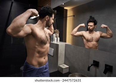 Caucasian man flexing muscles in the mirror - Powered by Shutterstock