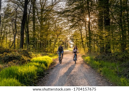 Similar – Radfahrer auf Waldweg