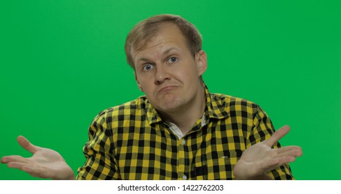 Caucasian man in glasses, doing gesture with hands like I don't know or whatever on the chroma key background. Green screen. - Powered by Shutterstock