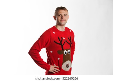 Caucasian Man With Hand On Hips Whilst Wearing A Christmas Jumper Looking To Camera