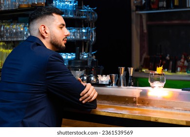 Caucasian man hanging out drinking whiskey on bar counter at luxury nightclub on weekend vacation. Bartender making mixed alcoholic cocktail drink for customer celebrating holiday party at restaurant. - Powered by Shutterstock